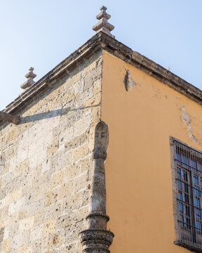 Historic Architectural Corner with Stone Masonry and Yellow Stucco