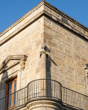 Historic Stone Building Corner with Ornate Wrought Iron Balcony