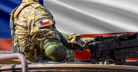 Chile flag with soldier at machine gun turret in front of it. Closeup side view. © lucky pics