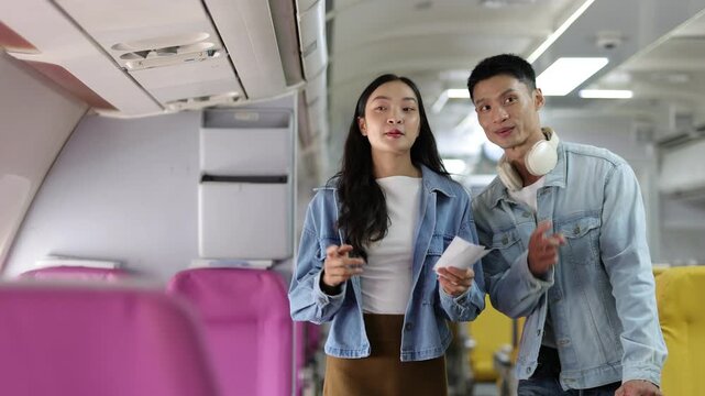 Young Asian couple boarding airplane for vacation travel.