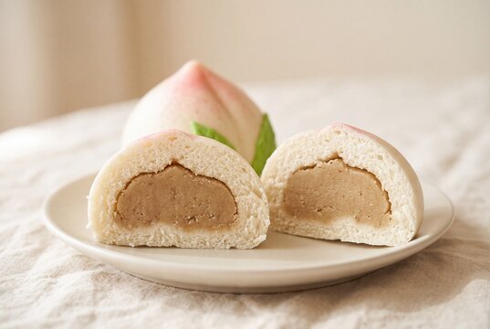 Longevity peach bun cut in half with lotus seed paste