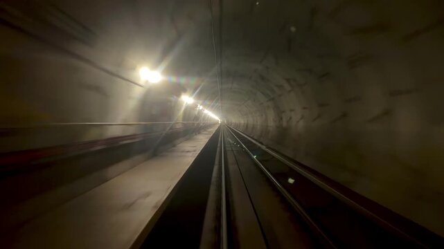 A forward-facing view of railway tracks from a train on Milan's M5 metro line, known for automated driverless operation. 