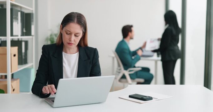 Portrait of tired businesswoman suffers from sudden migraine at laptop in office. Female employee feels stressed of workload pressure in corporate environment