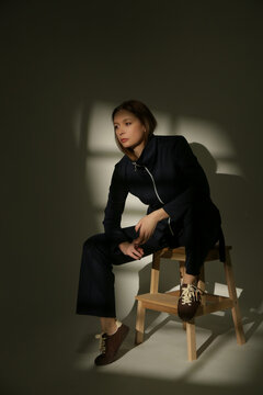 Stylish Female Model Wearing a Navy Blue Cotton Co-Ord Set in Dramatic Studio Lighting, Elegant Fashion Editorial with Strong Shadows and Light Contrast