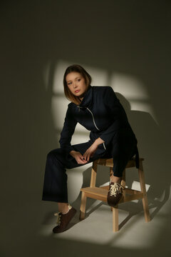 Stylish Female Model Wearing a Navy Blue Cotton Co-Ord Set in Dramatic Studio Lighting, Elegant Fashion Editorial with Strong Shadows and Light Contrast