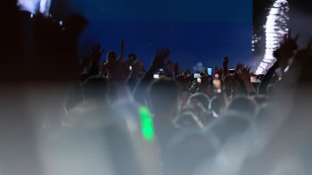 Huge crowd of music fans dancing wildly amid nighttime lights and special effects, stimulants, energy drinks, adrenaline rush, dopamine release, stress relief, inner freedom, euphoria, nightlife