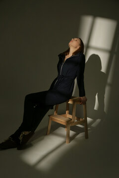 Stylish Female Model Wearing a Navy Blue Cotton Co-Ord Set in Dramatic Studio Lighting, Elegant Fashion Editorial with Strong Shadows and Light Contrast