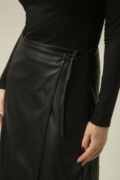 Close Up Studio Fashion Shot of Black Leather Midi Wrap Skirt with A Line Silhouette