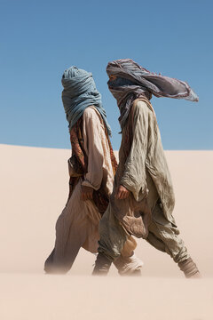 Two Travelers in Wrapped Headscarves Walking Through Minimal Desert Landscape