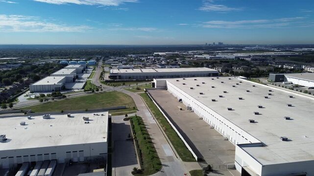 Concrete loading aprons border perimeter fence line Loop transit corridors along Northeast Loop. Concrete loading bays flank perimeter roads, security fencing, open truck, Haltom City, Texas