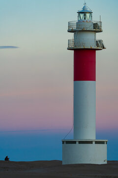 Lonely lighthouse at pastel dusk seaside horizon