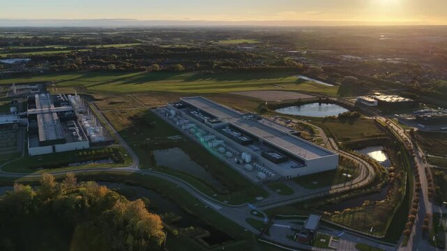Aerial footage of data center campus with server buildings,cooling systems and technological infrastructure integrated with sustainable green spaces in Odense, Denmark.