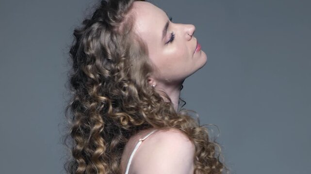 Sensual young woman flaunts shiny hairstyle after restorative scalp treatment.