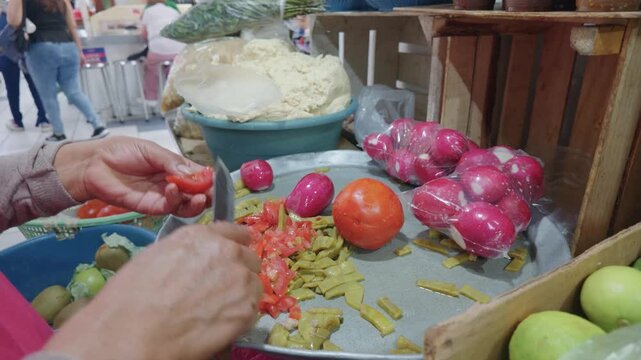Female Hands Preparing a Nopal and Tomato Salad at a Mexican Market