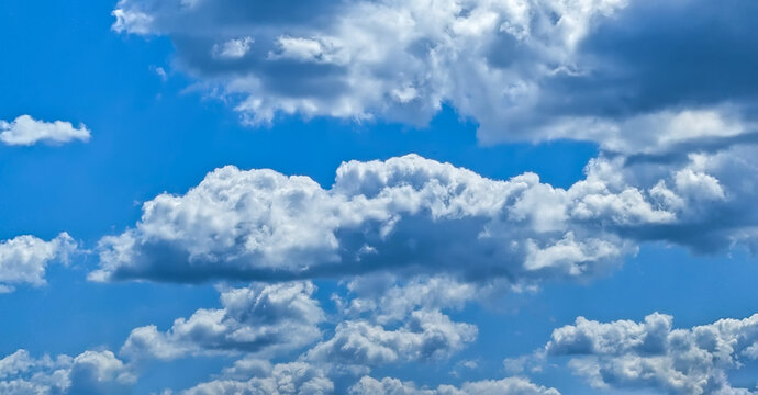 A raster image of a some cloud photographed against a blue sky. Easy relaxed cottony shape. Background quiet sky. Fiber contours after rain. Lonely free substance water. Trivial form of freedom.