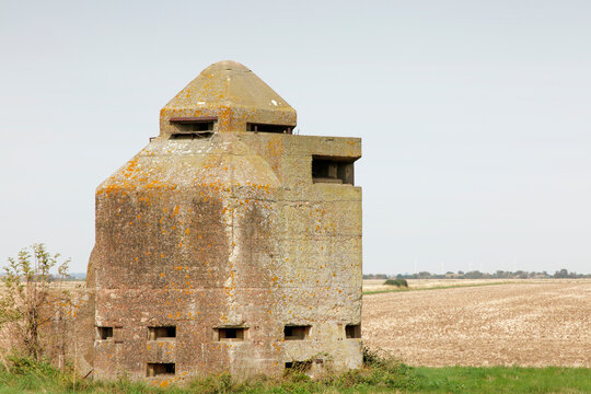 Abandoned WWII Concrete Bunker Pillbox in Rural Field Covered With Lichen and Moss
