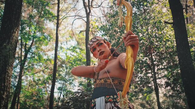 Traditional Indonesian Archer with Bow in a Forest Setting