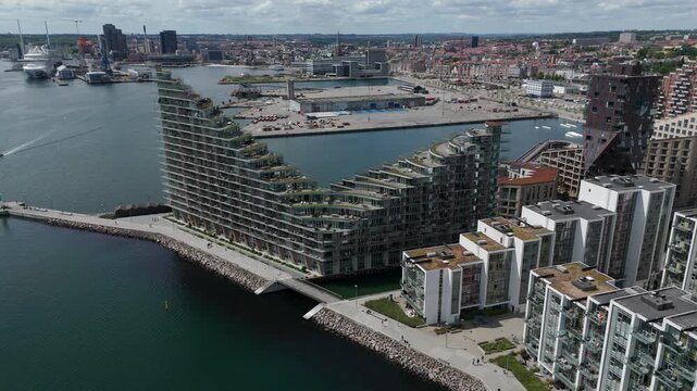 Aerial tilt-down shot showing modern buildings in the Aarhus Docklands neighborhood during daytime in Aarhus, Denmark.	
