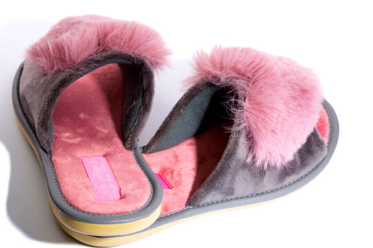 Pink  women's slippers on a white background