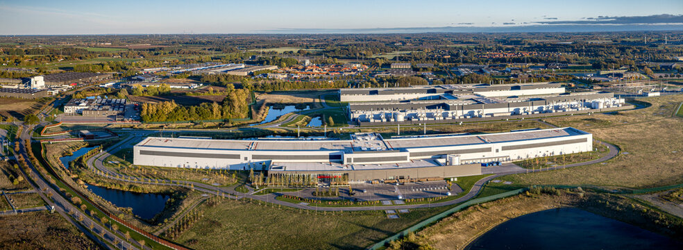 Aerial panorama of massive technology data center and server farm infrastructure complex located in an industrial landscape. Modern large scale cloud data center facility in Odense, Denmark.