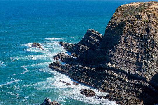Dramatic Coastal Cliffs Over Turquoise Ocean Waves