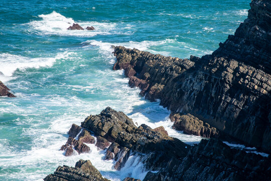 Rugged Coastal Cliffs with Turbulent Turquoise Waves