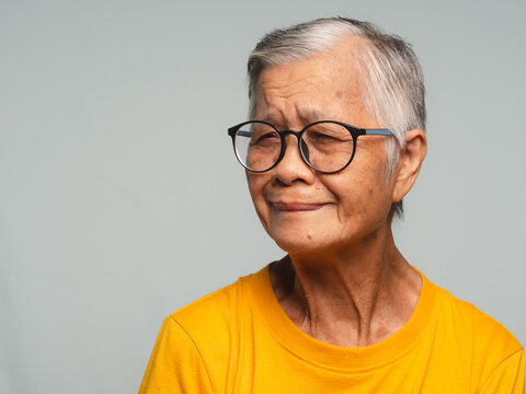 Smiling senior woman wearing glasses in close-up portrait 
