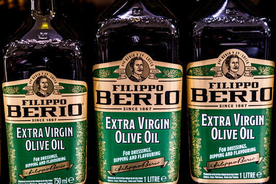 Close-Uo Of A Row Of Filippo Berio Extra Virgin Olive Oil Bottles On A UK Supermarket Shelf