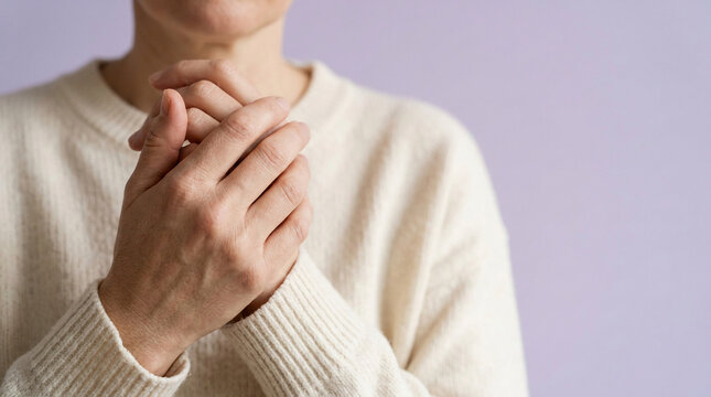 Person's hands gently clasped, reflecting introspection, concern, or self-comfort, underscoring the universal importance of Mental Health awareness