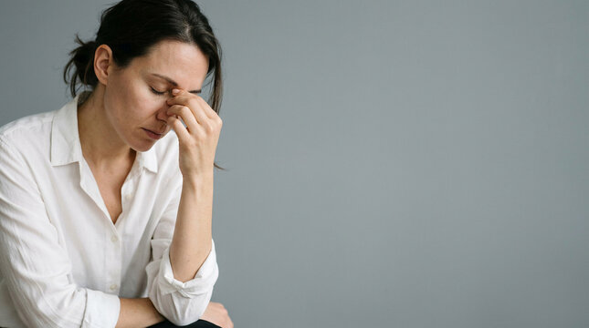A woman experiencing deep emotional distress, a poignant representation of unseen battles with fatigue or anxiety. This highlights the crucial need for Mental Health awareness and empathetic support