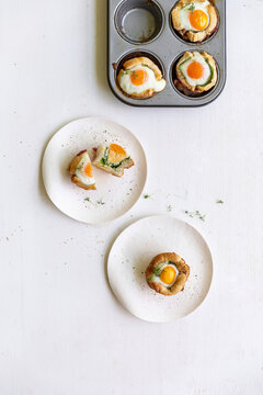 Toasted savory muffins with spinach and baked eggs in muffin tin