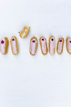 Eclairs with pink glaze and rose petal decorations