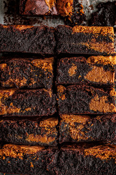 Brownie squares with caramel and Biscoff biscuit swirls