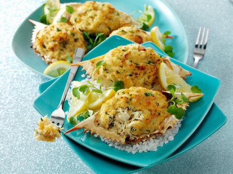 Caribbean Crab Farci stuffed blue Crab on coarse sea salt with lemon
