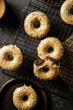 Chocolate donuts topped with caramel glaze and sprinkles