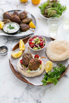 Lamb kofta with pita bread, salad, and tzatziki sauce