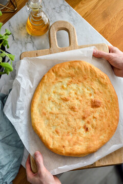 Khachapuri Georgian cheese bread on wooden cutting board