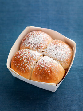 Buchteln yeast dough rolls in a cardboard box on a blue background