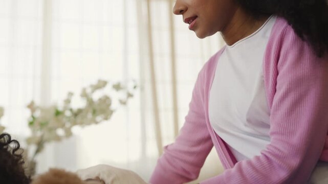 African American mother caring for tired little son before daytime sleep