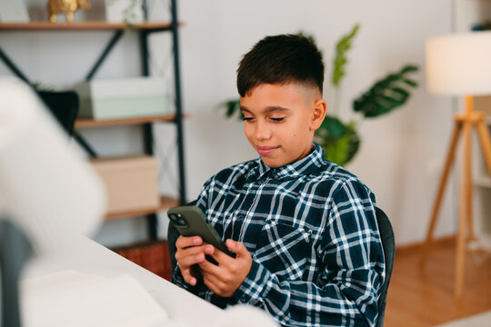 Young boy using smartphone for digital learning and communication