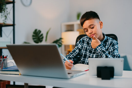 Young boy learning online and doing homework