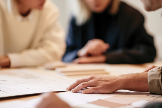 A collaborative moment captured in this image, showing professionals engaged in discussion over design concepts, illustrating teamwork and creativity within the workspace.