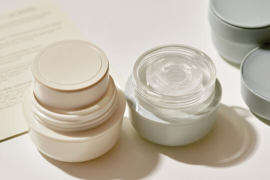 The image features two jars of cream with modern lids, showcasing stylish packaging that appeals to consumers looking for contemporary skincare solutions.
