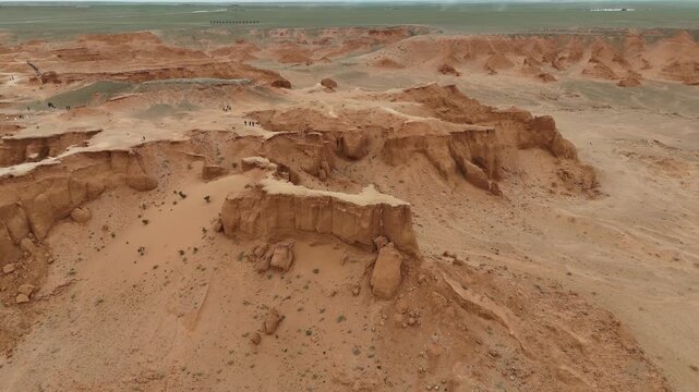 Aerial drone perspective of eroded red sandstone formations and rugged desert badlands at the Flaming Cliffs in the Gobi Desert, Mongolia