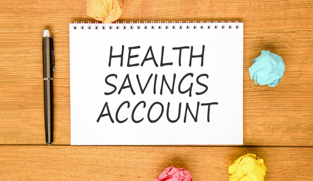 Health saving account symbol. Concept words Health saving account on beautiful white note. Beautiful wooden background. Colored paper. Medical Health saving account concept. Copy space.