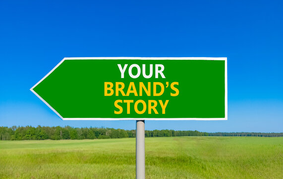 Branding and your brands story symbol. Concept words Your brands story on beautiful green road sign. Beautiful blue sky green grass background. Business branding your brands story concept. Copy space