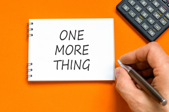 One more thing words symbol. Concept words One more thing on beautiful white note. Beautiful orange background. Businessman hand. Business and one more thing concept. Copy space.