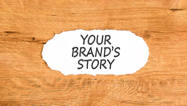 Branding and your brands story symbol. Concept words Your brands story on beautiful white paper. Beautiful wooden background. Business branding your brands story concept. Copy space.