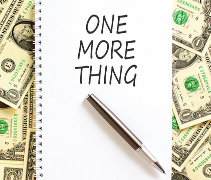 One more thing words symbol. Concept words One more thing on beautiful white note. Beautiful dollar bills background. Business and one more thing concept. Copy space.