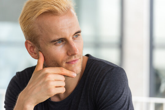 Portrait Caucasian man blue eyes blond hair smiling face headshot in studio. Handsome White people men look at camera standing in casual clothing. Portrait Happy Confidence cheerful businessman